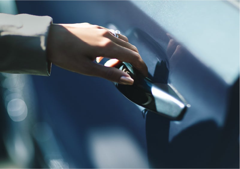 A hand gracefully grips the Light Touch Handle of a 2023 Lincoln Aviator® SUV to demonstrate its ease of use | Parks Lincoln of Gainesville in Gainesville FL